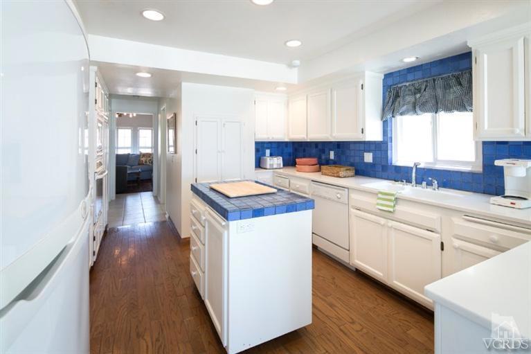 4025 Ocean Drive Oxnard, CA 93035 - Photo 22 of 31 a kitchen with a sink stove and cabinets