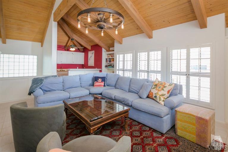 4025 Ocean Drive Oxnard, CA 93035 - Photo 24 of 31 a living room with furniture a chandelier and a large window
