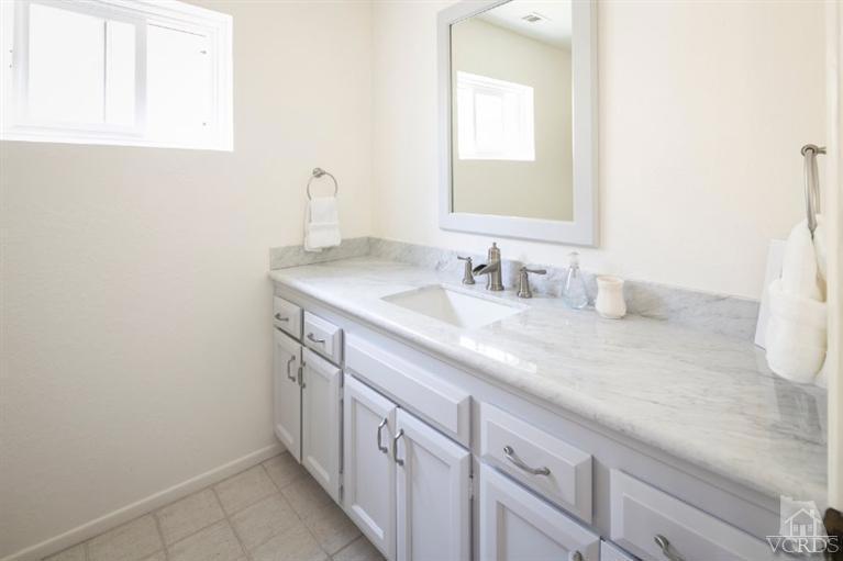 4025 Ocean Drive Oxnard, CA 93035 - Photo 27 of 31 a bathroom with a sink and a mirror