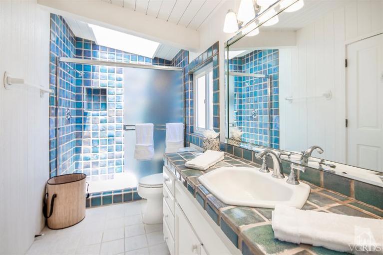 4025 Ocean Drive Oxnard, CA 93035 - Photo 29 of 31 a bathroom with a double vanity sink toilet and shower