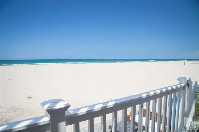 a view of a room with wooden floor and chair