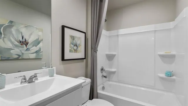 a bathroom with a toilet sink and shower