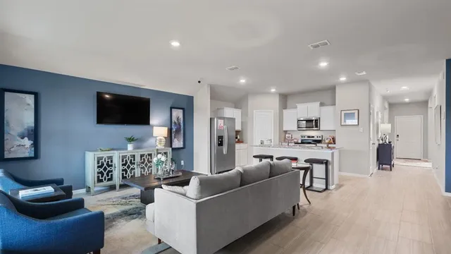 a kitchen with stainless steel appliances granite countertop a sink and a refrigerator