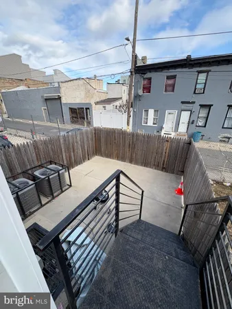 a view of a patio with couches chairs and wooden floor