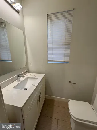 a bathroom with a sink a toilet and mirror
