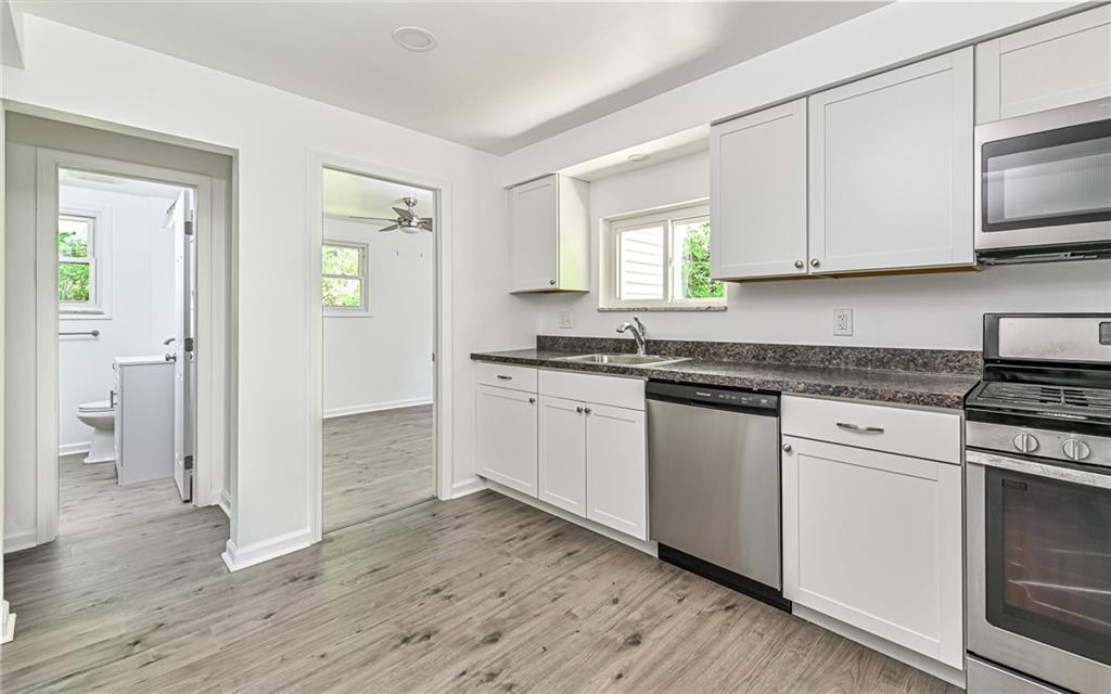 46 Winchell Street Pittsburgh, PA 15215 - Photo 7 of 18 Stainless steel appliances with gas stove, over the range microwave, dishwasher and refrigerator.