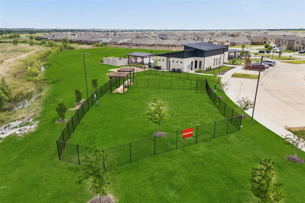 14163 Kempt Drive Pilot Point, TX 76258 - Photo 27 of 29 Treat your furry friends to their own neighborhood destination with the community dog park, complete with expansive fenced green space and shaded areas for play, exercise, and socializing.