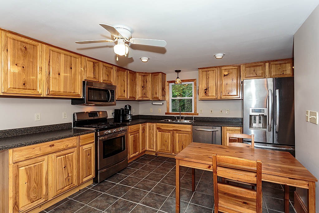 32 Harding Street Chelmsford, MA 01863 - Photo 3 of 30 a kitchen with stainless steel appliances granite countertop a sink a stove cabinets counter space and a window