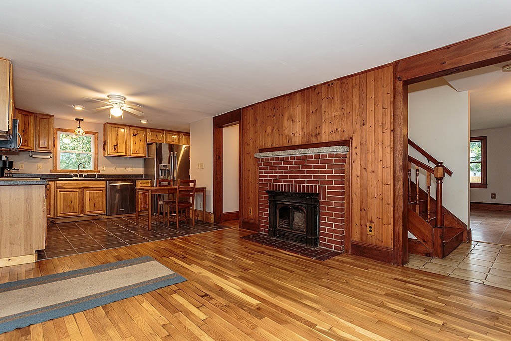 32 Harding Street Chelmsford, MA 01863 - Photo 5 of 30 a living room with stainless steel appliances furniture a fireplace and a flat screen tv