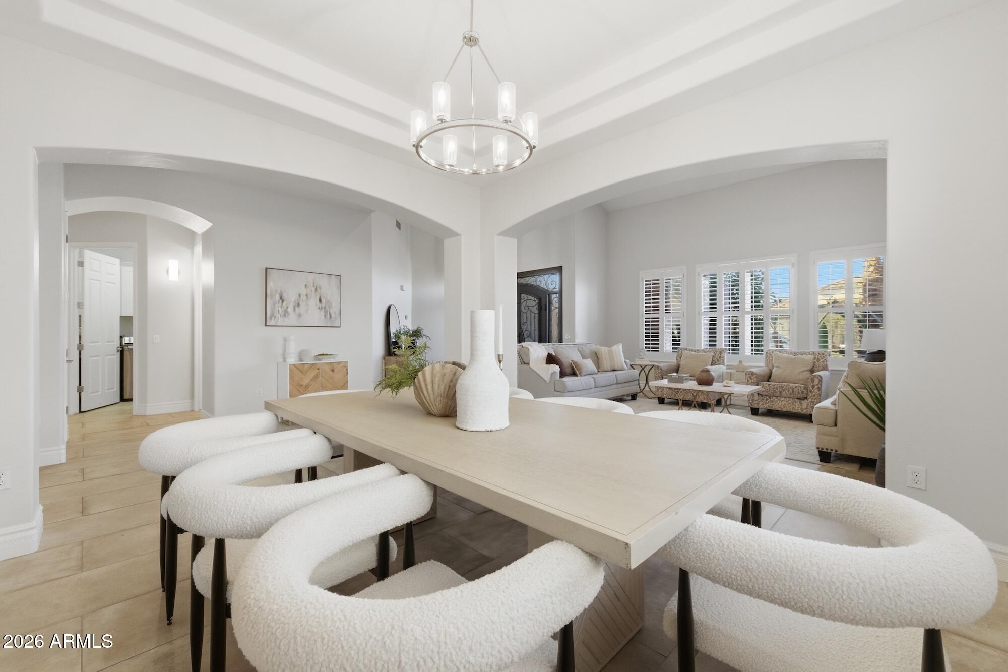 3425 East Mockingbird Drive Gilbert, AZ 85234 - Photo 14 of 52 a view of a dining room with furniture and wooden floor