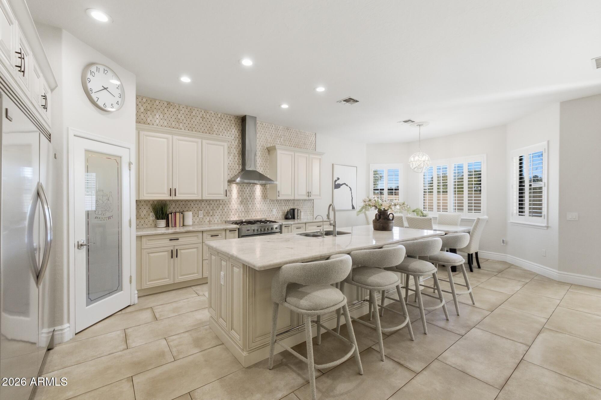 3425 East Mockingbird Drive Gilbert, AZ 85234 - Photo 15 of 52 a large kitchen with a table and chairs in it