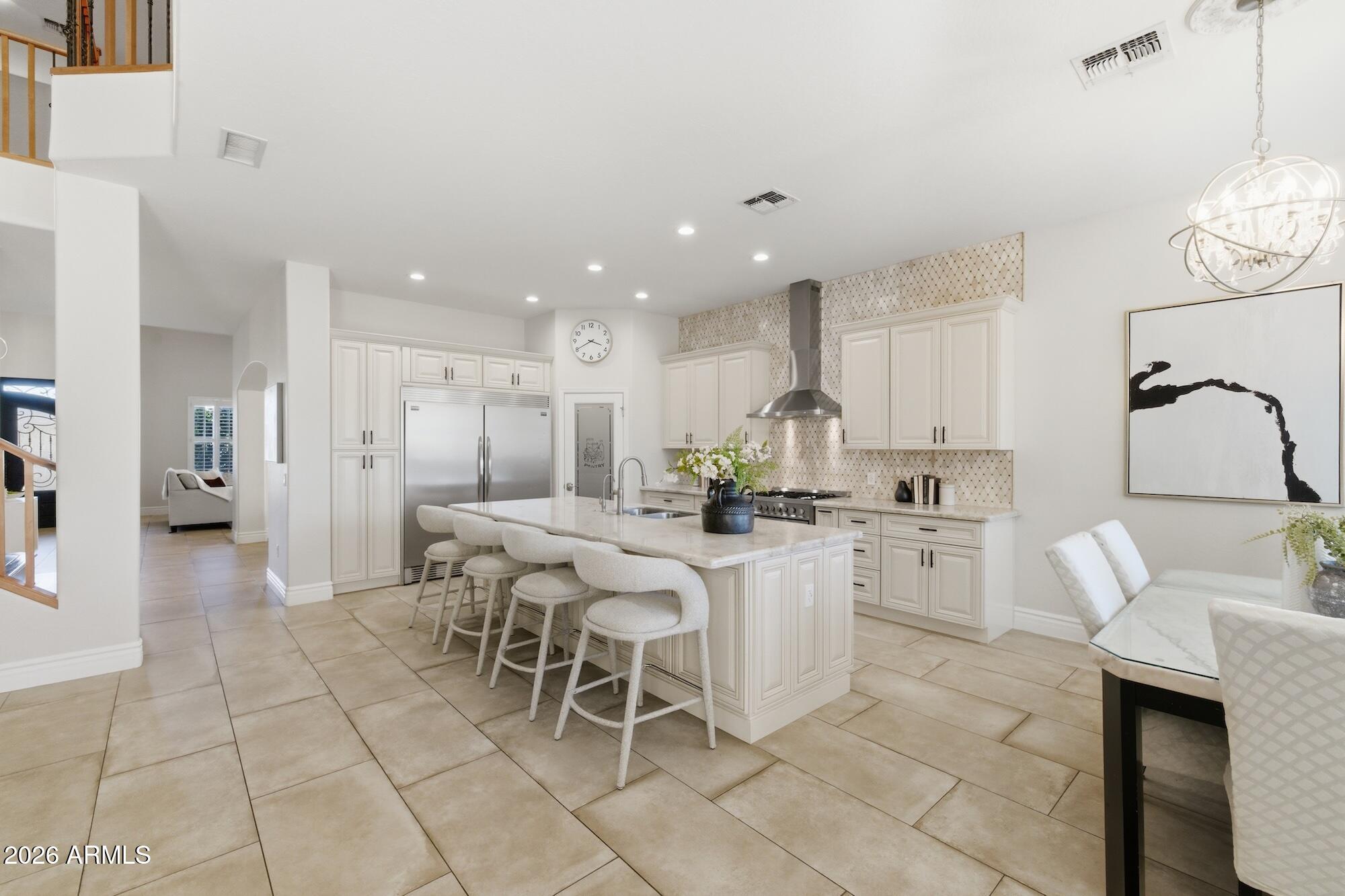 3425 East Mockingbird Drive Gilbert, AZ 85234 - Photo 16 of 52 a kitchen with stainless steel appliances kitchen island granite countertop a sink and cabinets