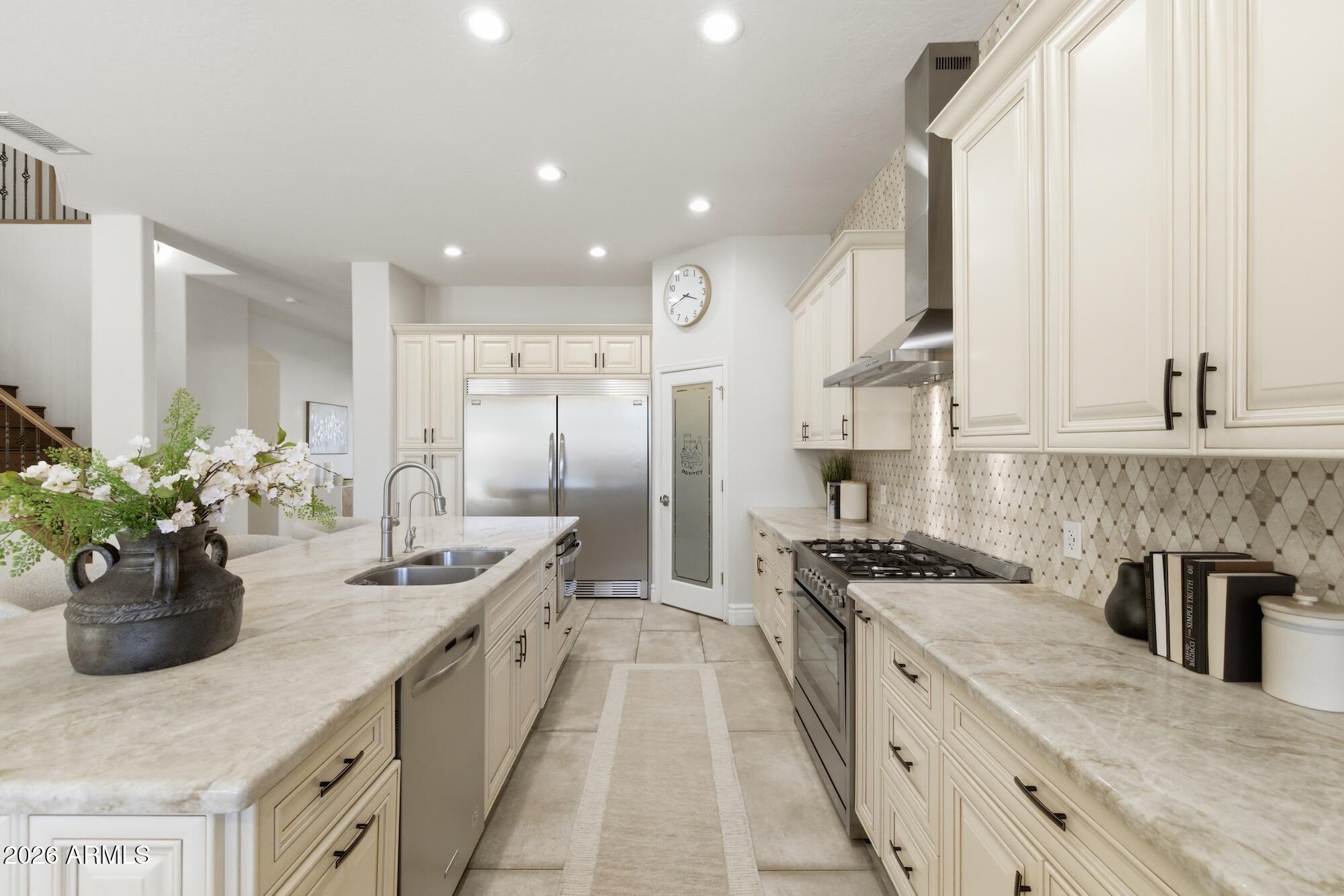 3425 East Mockingbird Drive Gilbert, AZ 85234 - Photo 17 of 52 a kitchen with kitchen island granite countertop a sink stainless steel appliances and cabinets