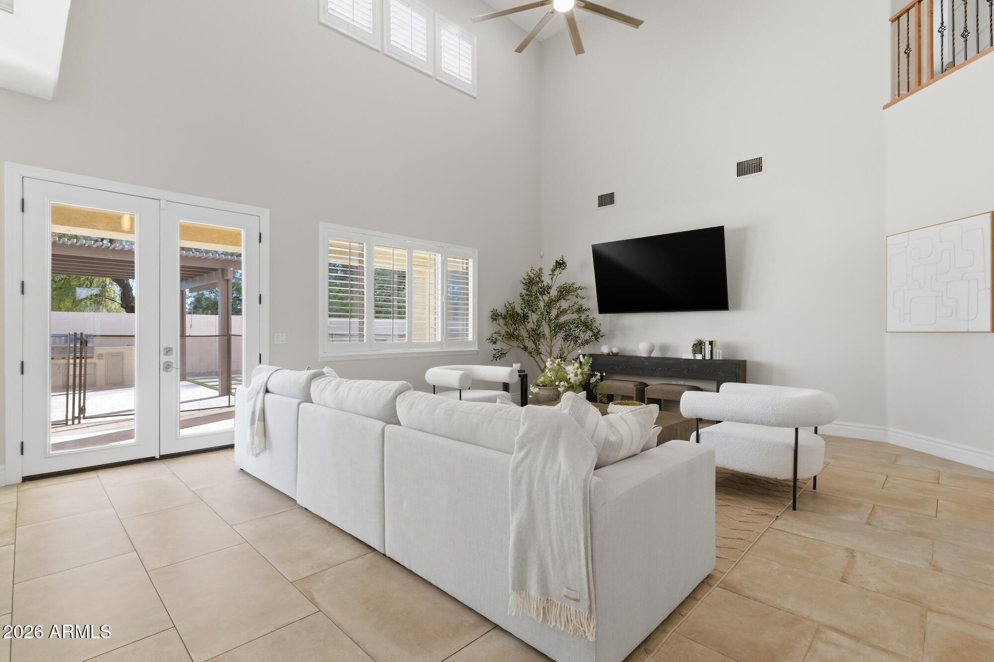 3425 East Mockingbird Drive Gilbert, AZ 85234 - Photo 19 of 52 a living room with furniture and a flat screen tv