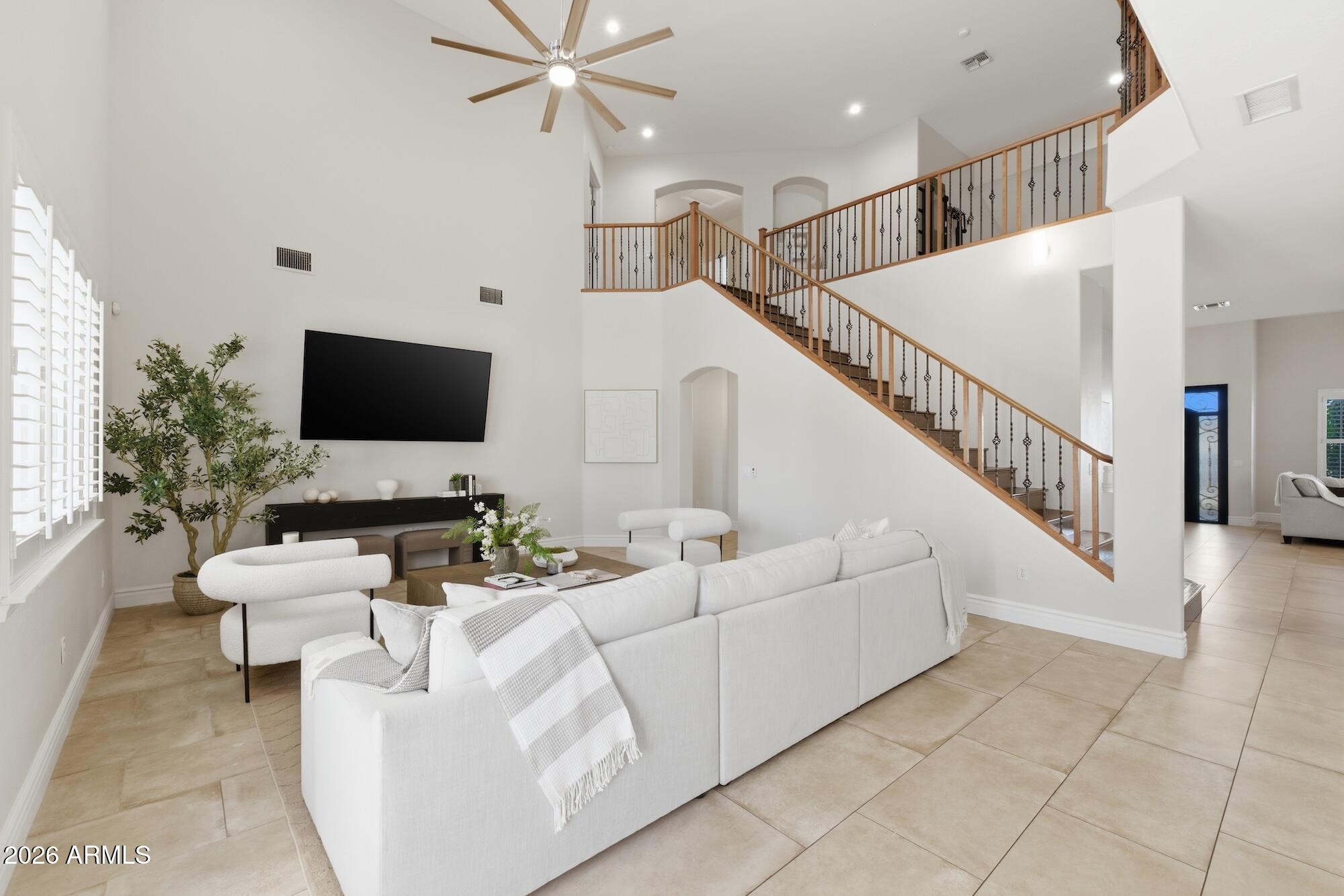 3425 East Mockingbird Drive Gilbert, AZ 85234 - Photo 20 of 52 a living room with furniture and a flat screen tv