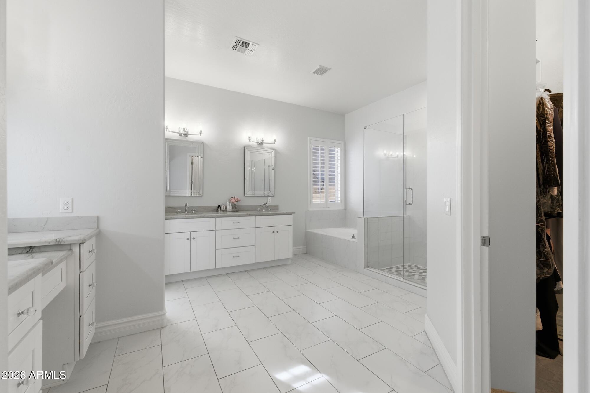 3425 East Mockingbird Drive Gilbert, AZ 85234 - Photo 24 of 52 a bathroom with a sink a mirror and a shower