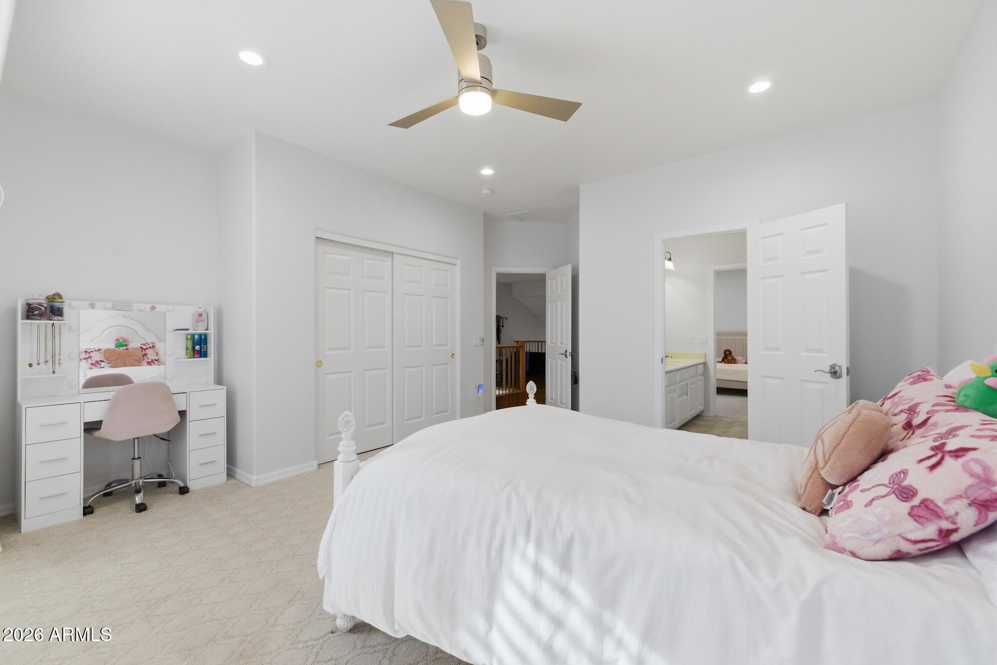 3425 East Mockingbird Drive Gilbert, AZ 85234 - Photo 29 of 52 a spacious bedroom with a bed and a chandelier