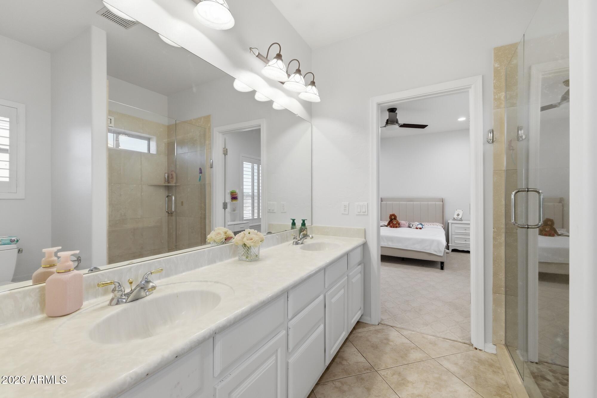 3425 East Mockingbird Drive Gilbert, AZ 85234 - Photo 32 of 52 a en suite spacious bathroom with a double vanity sink and a mirror