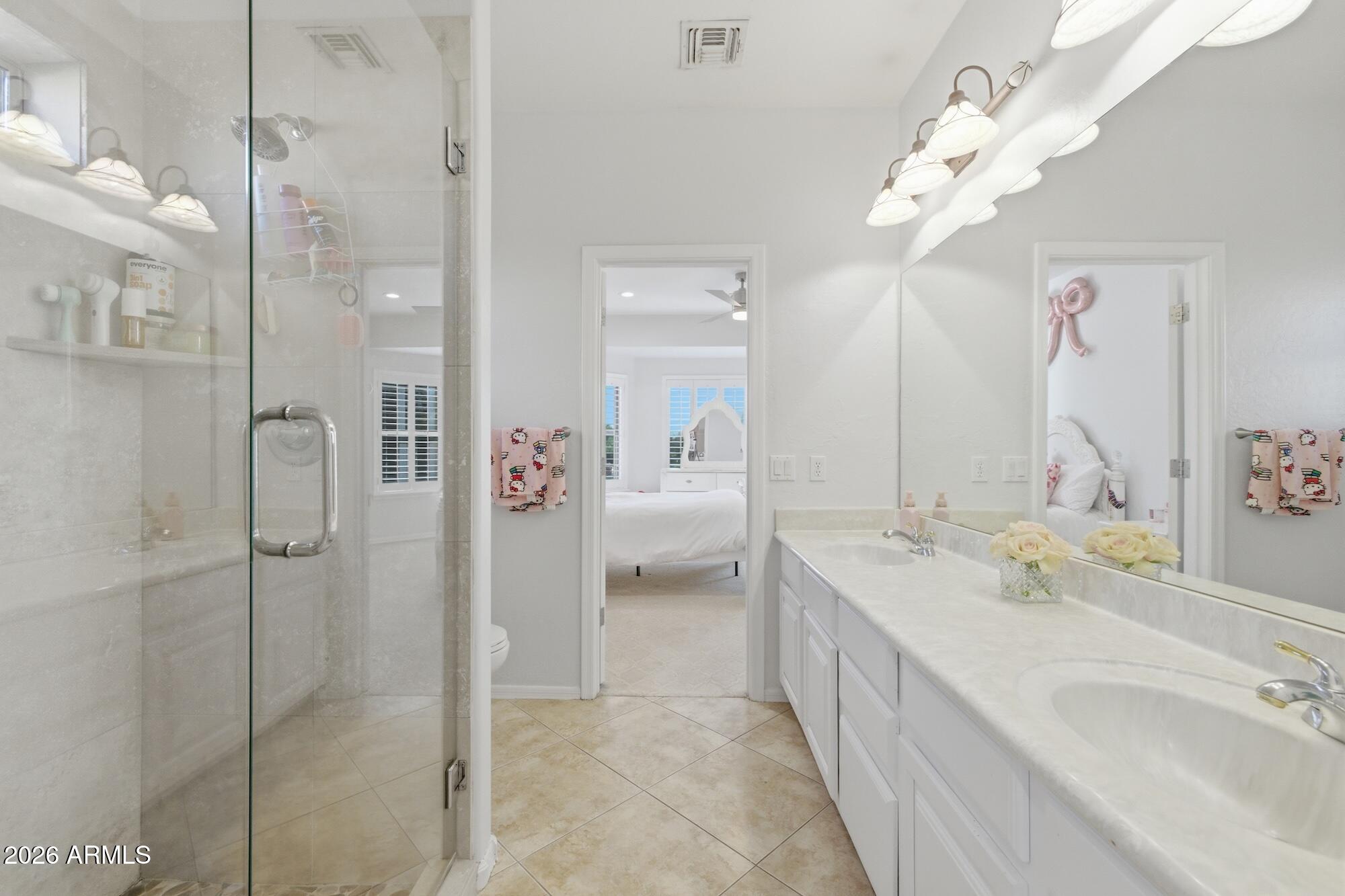 3425 East Mockingbird Drive Gilbert, AZ 85234 - Photo 33 of 52 a bathroom with a double vanity sink mirror and shower