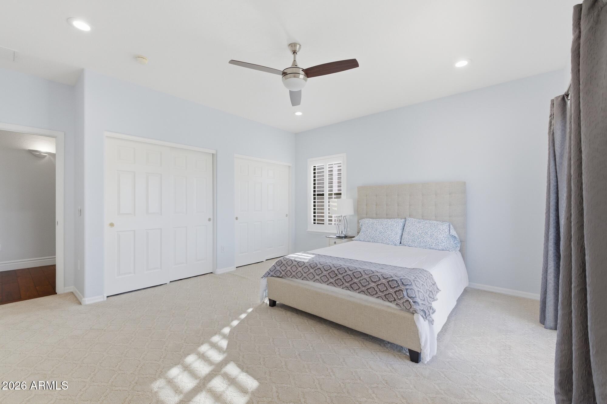 3425 East Mockingbird Drive Gilbert, AZ 85234 - Photo 37 of 52 a bedroom with a bed and a ceiling fan