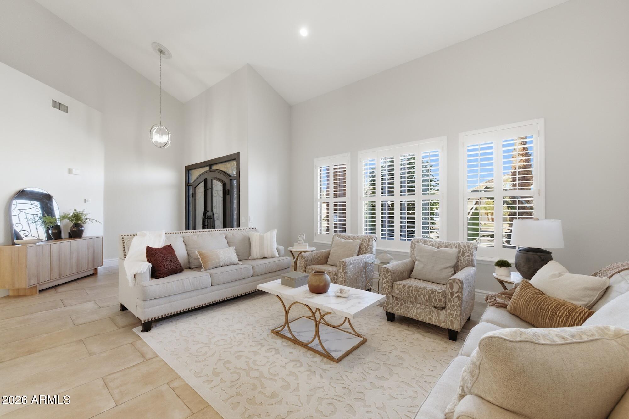 3425 East Mockingbird Drive Gilbert, AZ 85234 - Photo 4 of 52 a living room with furniture and a large window