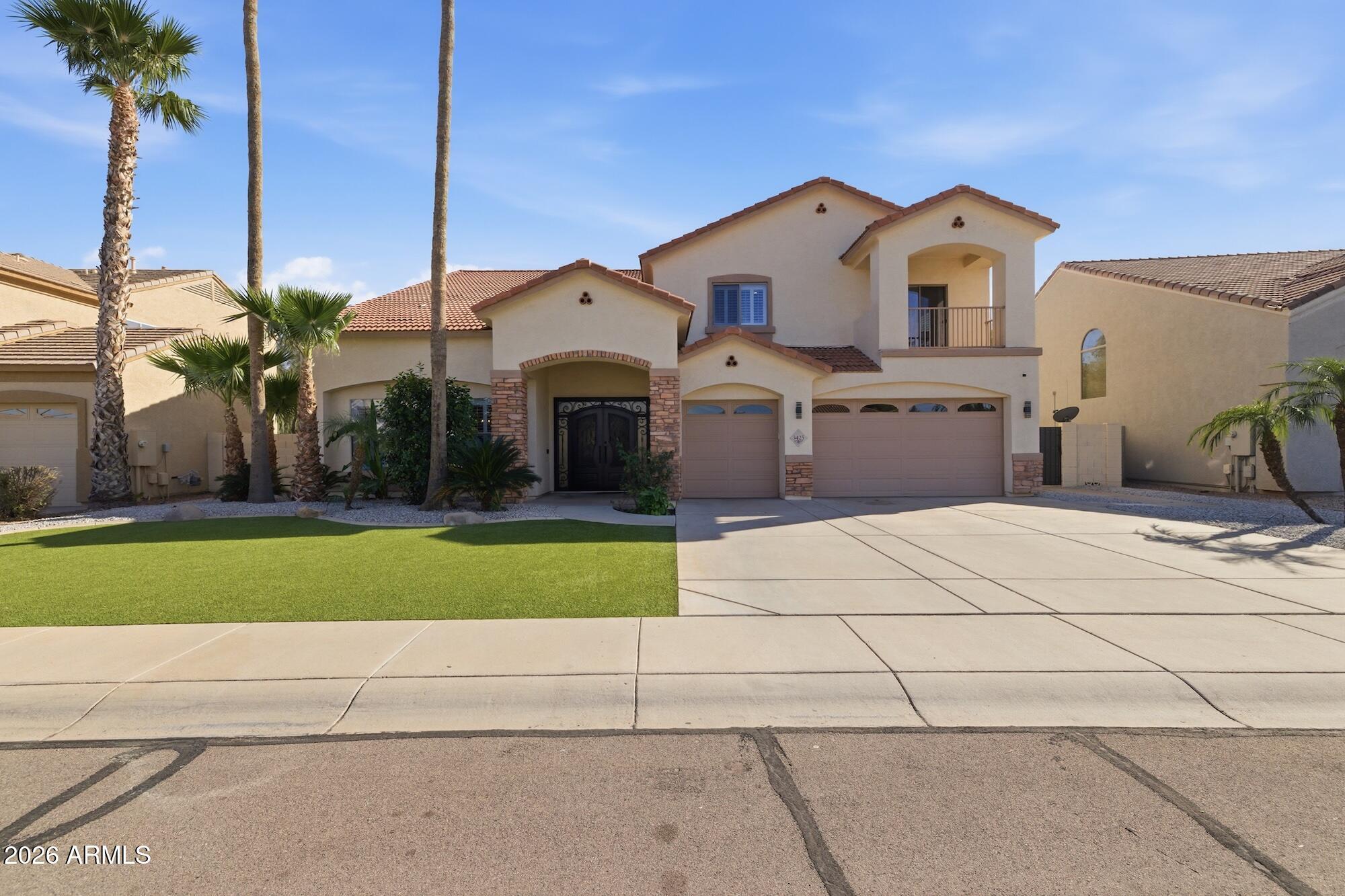 3425 East Mockingbird Drive Gilbert, AZ 85234 - Photo 9 of 52 a front view of a house with a yard and garage