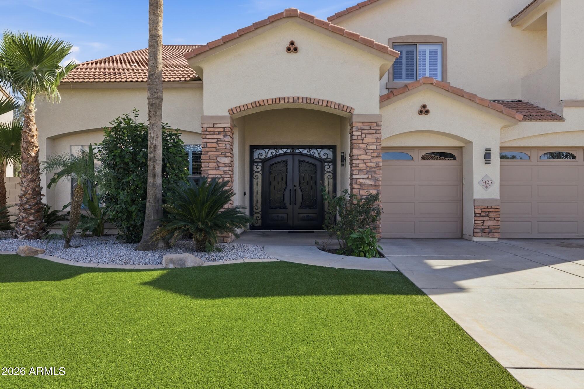3425 East Mockingbird Drive Gilbert, AZ 85234 - Photo 10 of 52 a front view of a house with a yard and garage