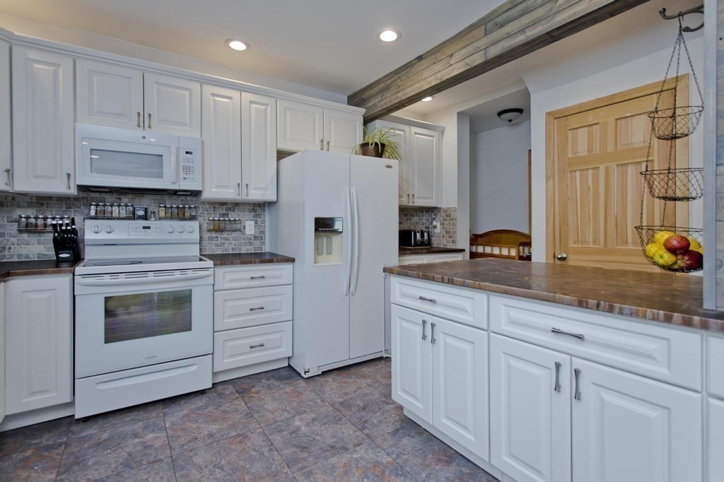 180 Granby Road Chicopee, MA 01013 - Photo 6 of 30 a kitchen with white cabinets and white appliances