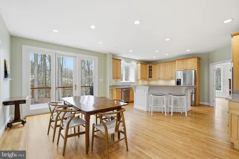 a dining room with furniture and wooden floor