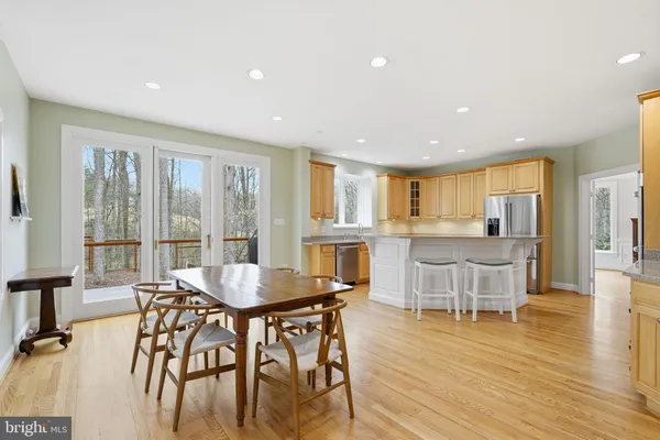 a dining room with furniture and wooden floor