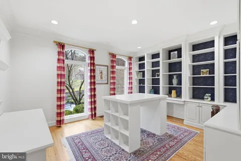 a view of a bedroom with wooden floor and furniture