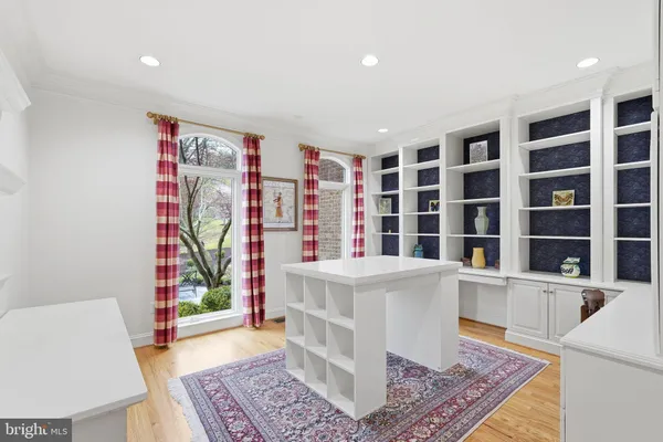 a view of a bedroom with wooden floor and furniture