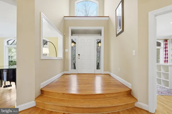 a view of a livingroom with wooden floor and staircase