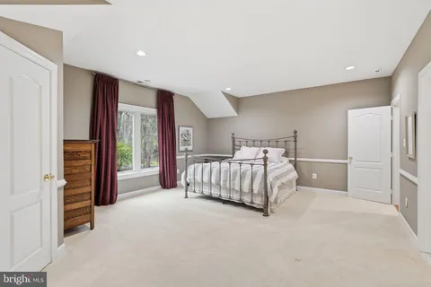 a kitchen with stainless steel appliances a refrigerator a stove a dining table and chairs