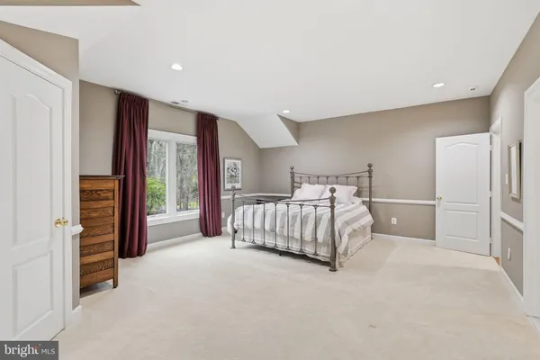 a kitchen with stainless steel appliances a refrigerator a stove a dining table and chairs