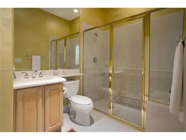 a bathroom with a sink mirror toilet and shower