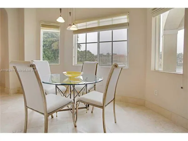 a view of a dining room with furniture and a window
