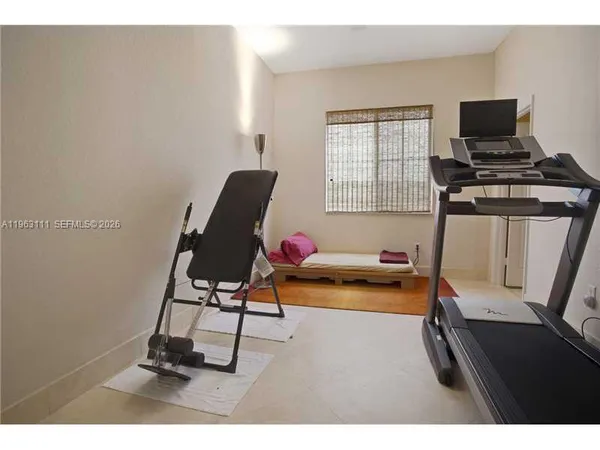 a living room with furniture a flat screen tv and a window