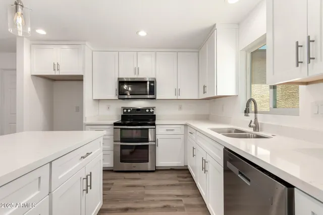 a close view of a sink and cabinets in a kitchen