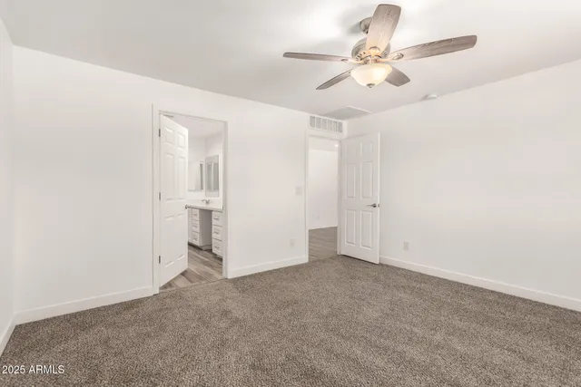 a spacious bathroom with a double vanity sink and mirror