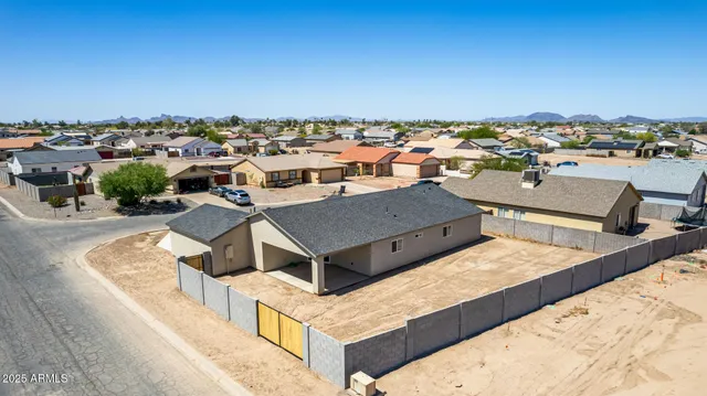 an aerial view of a house with a yard