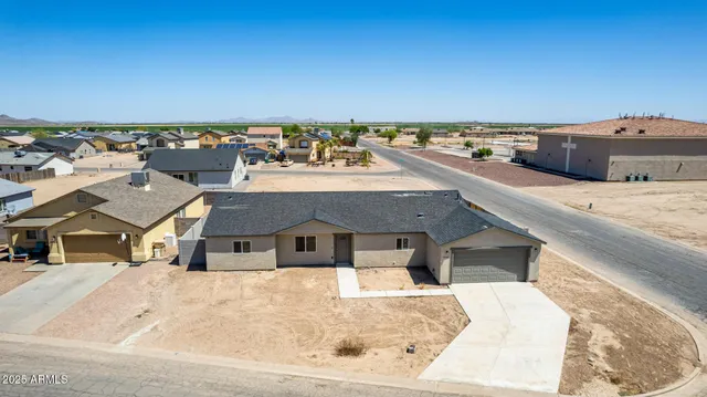 a view of a house with snow on the road