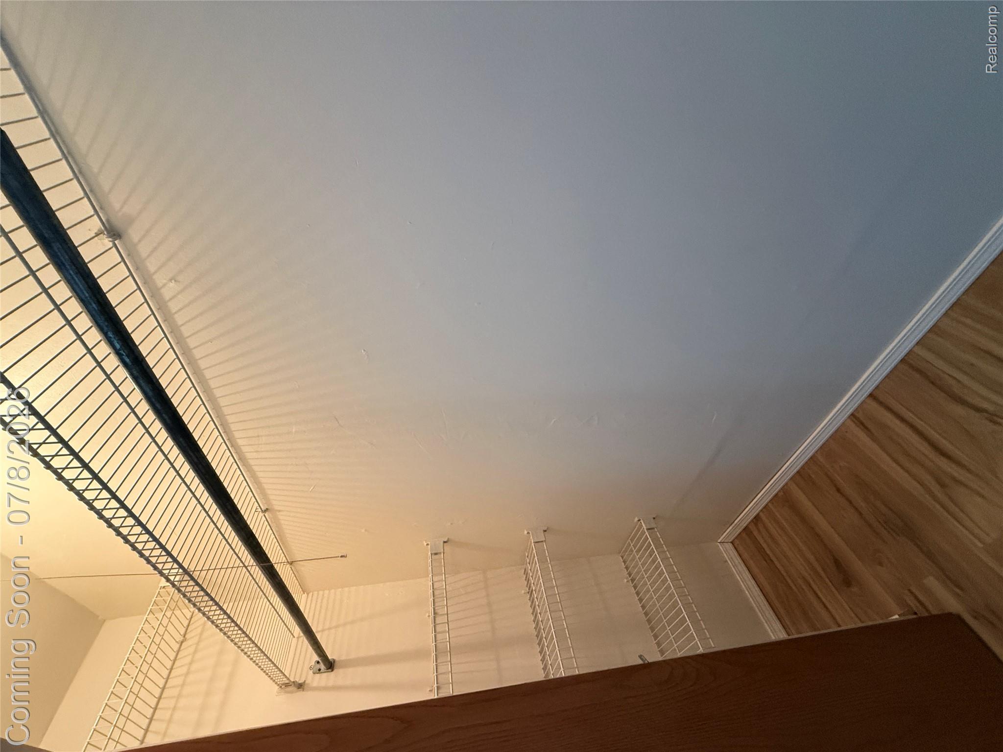 756 Cedarlawn Road Waterford, MI 48328 - Photo 13 of 34 White wire shelving system, full-width hanging rod, wood-finish flooring, and crisp white walls