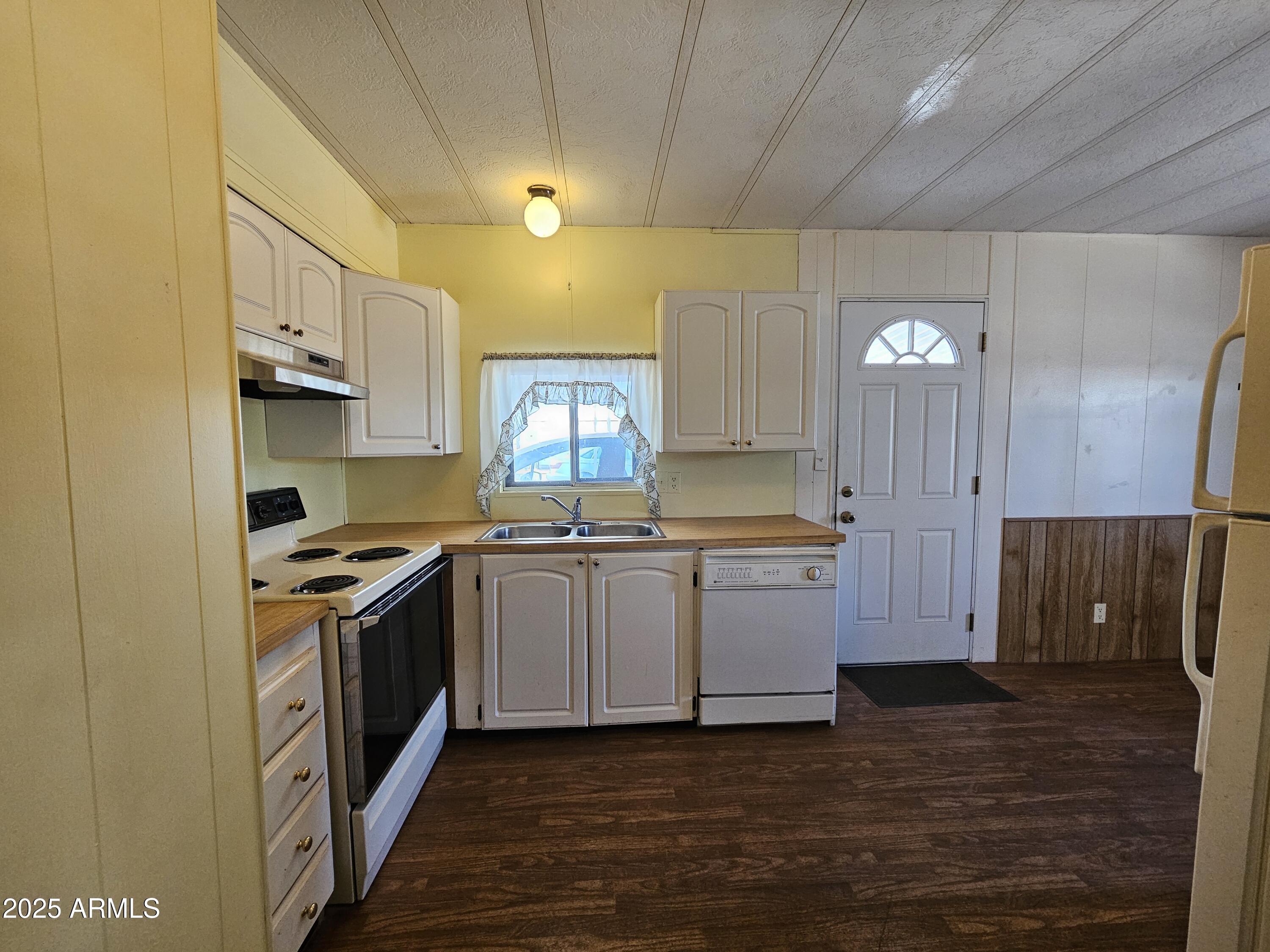 200 East Ivanhoe Street, Unit 60 Chandler, AZ 85225 - Photo 3 of 10 a kitchen with stainless steel appliances granite countertop a stove a sink and a refrigerator