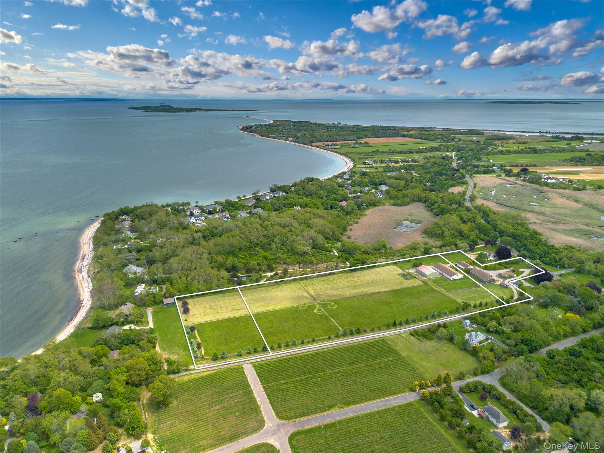 Aerial overview of property's location featuring property parcel outlined and a large body of water