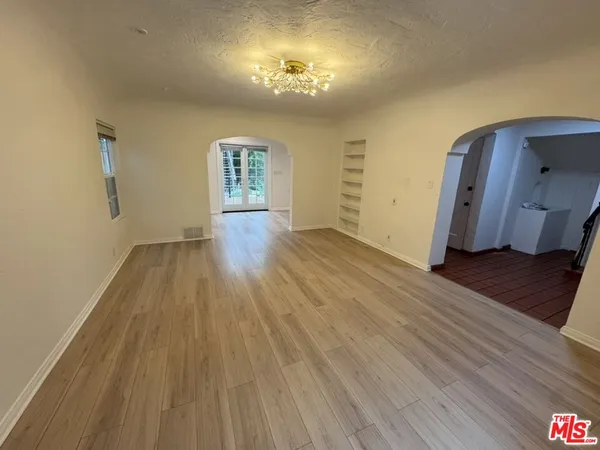 a view of a room with wooden floor and staircase