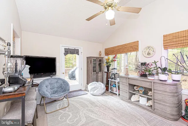 a bedroom with furniture and a flat screen tv