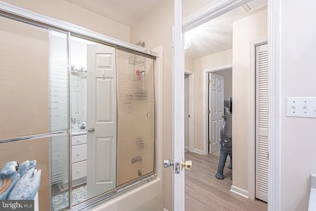 a bathroom with a shower and a glass door
