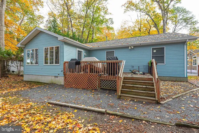 a view of a house with a yard and wooden fence