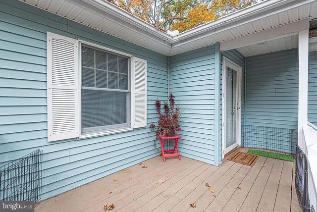a view of a deck with a chair and wooden floor